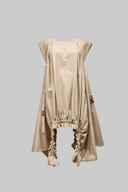Beige dress with lace details on a gray background