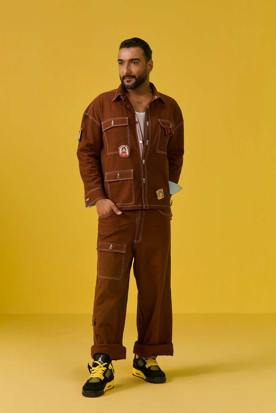 Man wearing a brown outfit with a yellow background