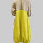 Two-tone dress with beige top and yellow bottom on a white background