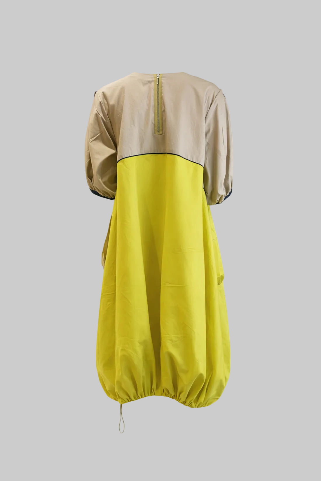 Two-tone dress with beige top and yellow bottom on a white background