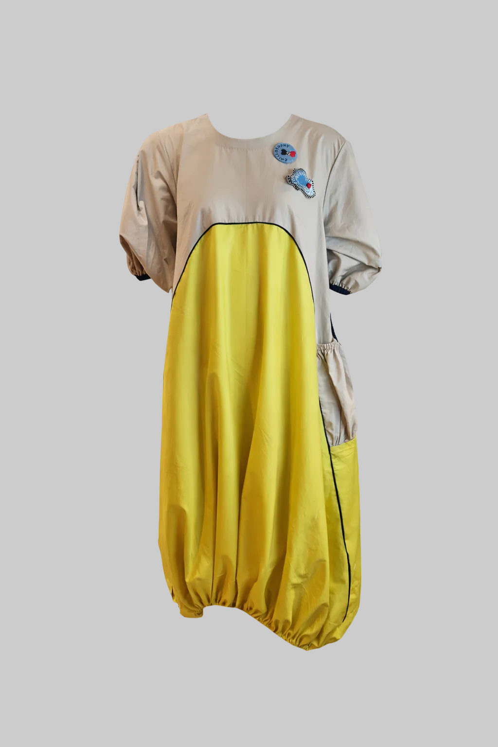 Balloon dress with a beige top and yellow bottom on a white background