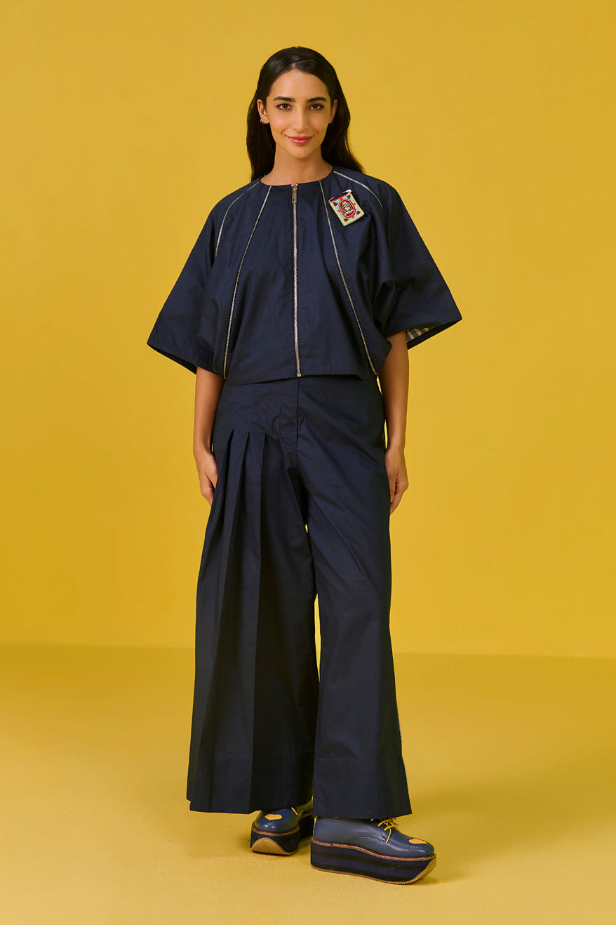 Woman wearing a navy outfit on a yellow background