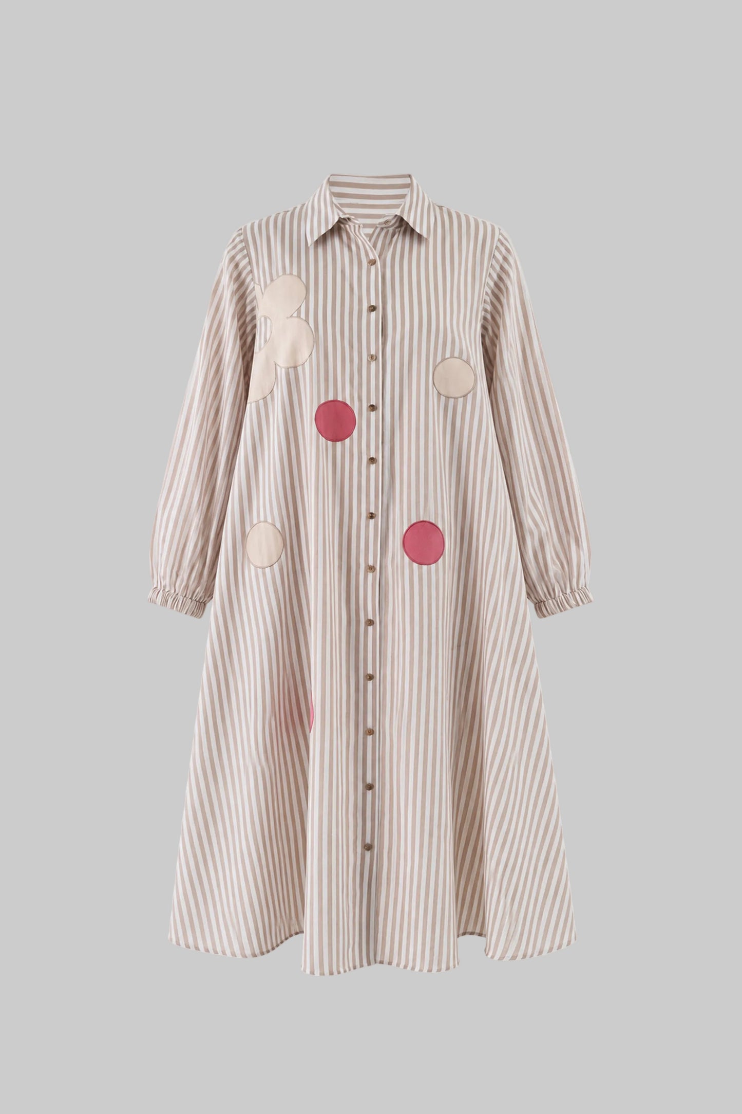 Striped shirt dress with circular patches on a light gray background