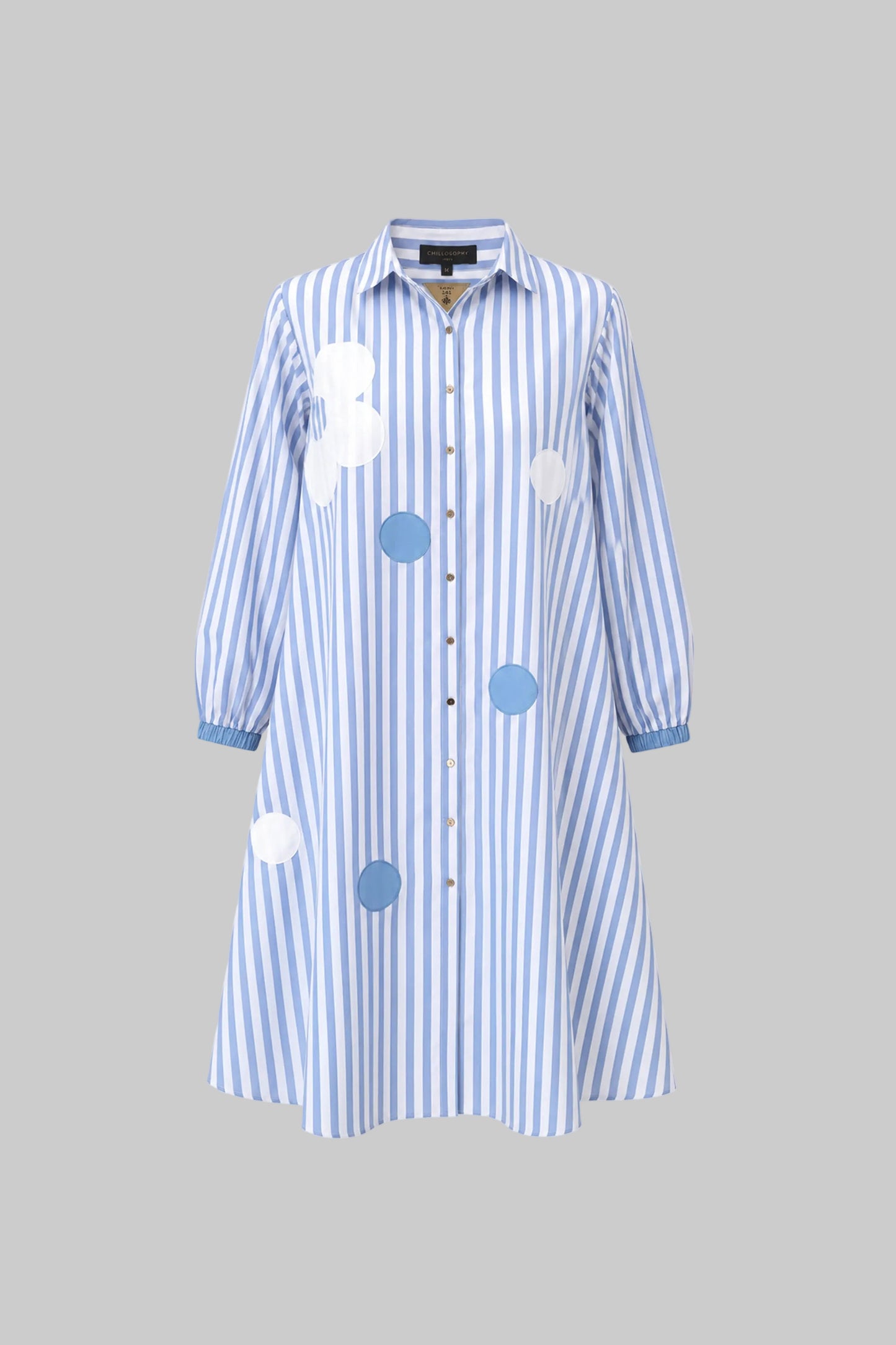 Blue and white striped dress with circular patterns on a gray background