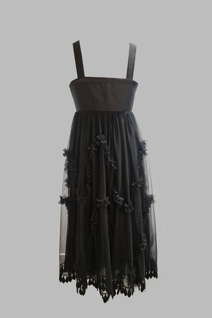Black dress with floral details on a gray background