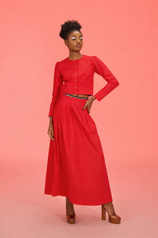 Woman wearing a red outfit on a pink background