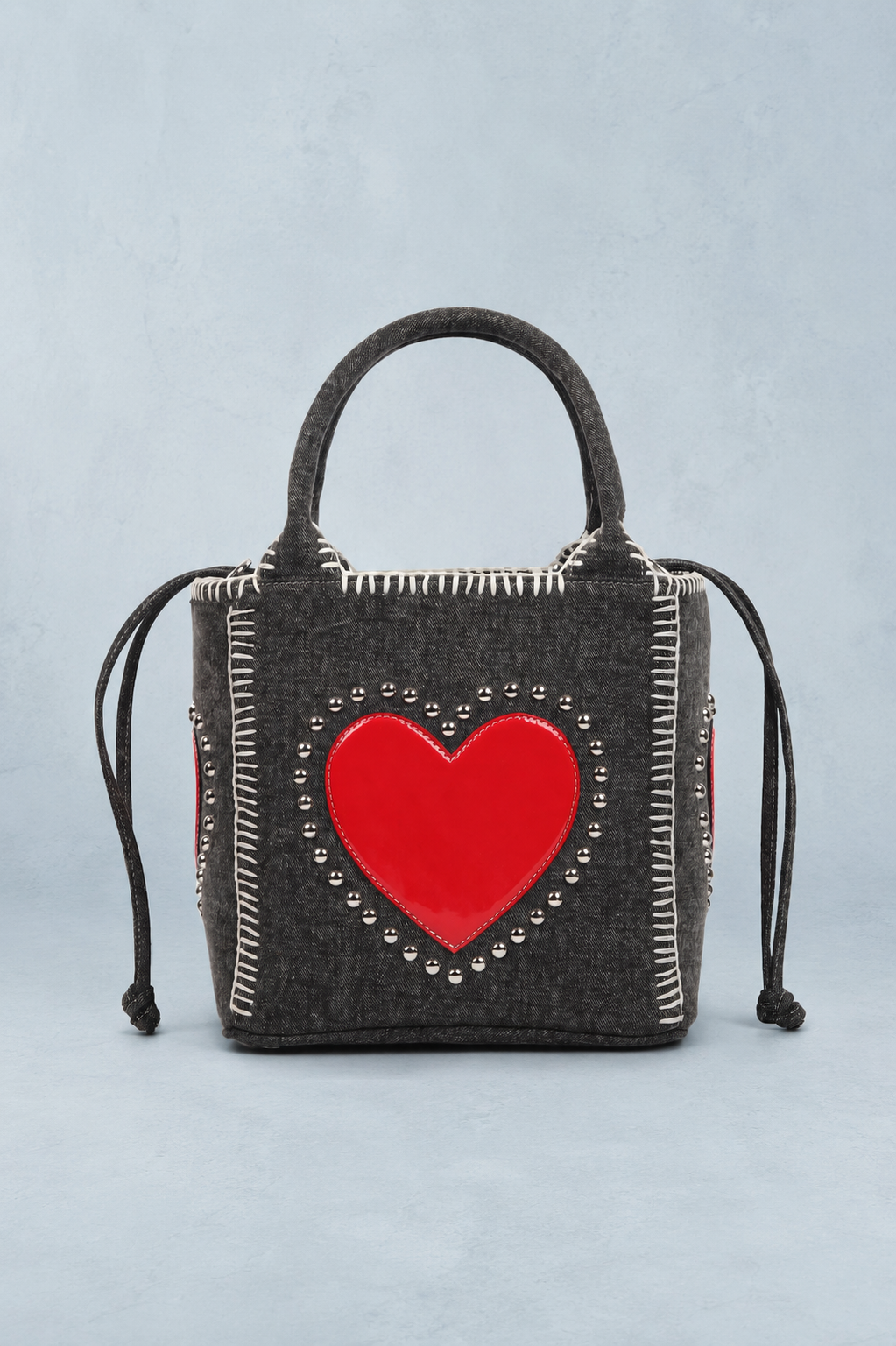 Handbag with a red heart design on a light blue background