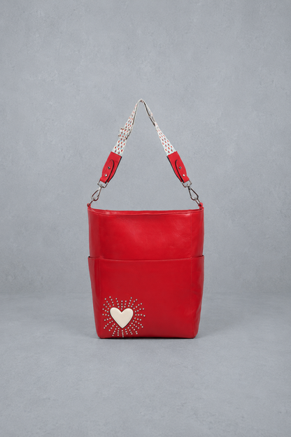 Red handbag with a heart design on a gray background