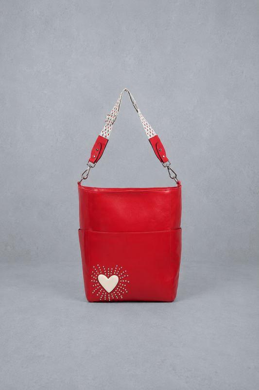 Red handbag with a heart design on a gray background