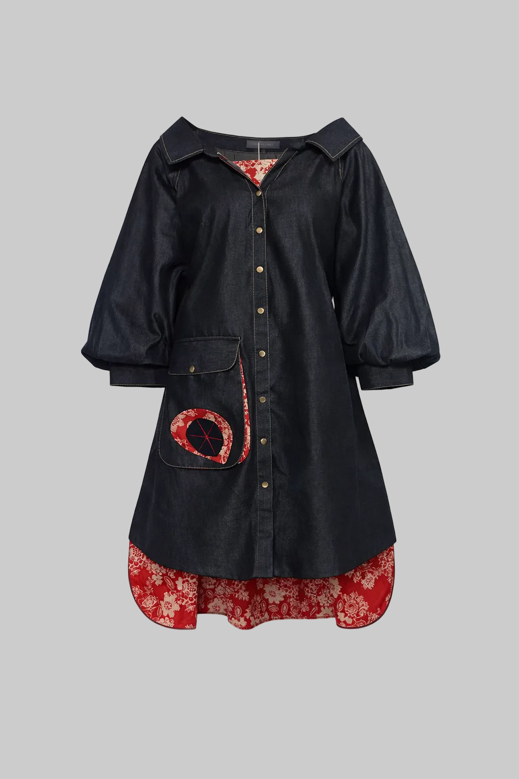 Black denim dress with floral red hem and pocket on a light gray background