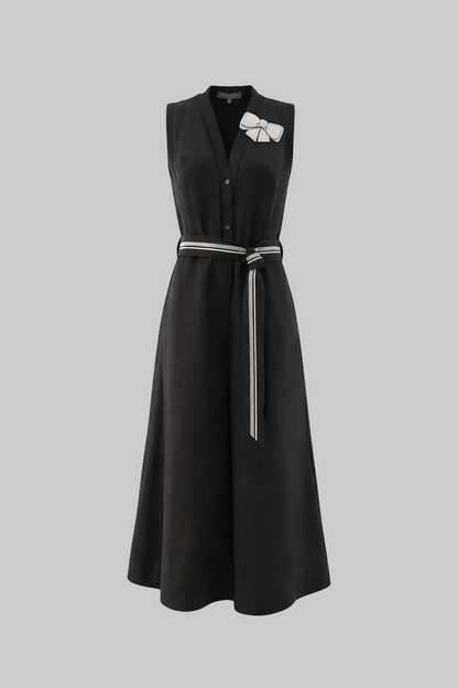 Black sleeveless dress with a belt on a white background