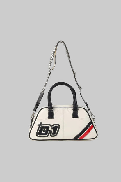 White handbag with black handle and red and black stripe on a gray background