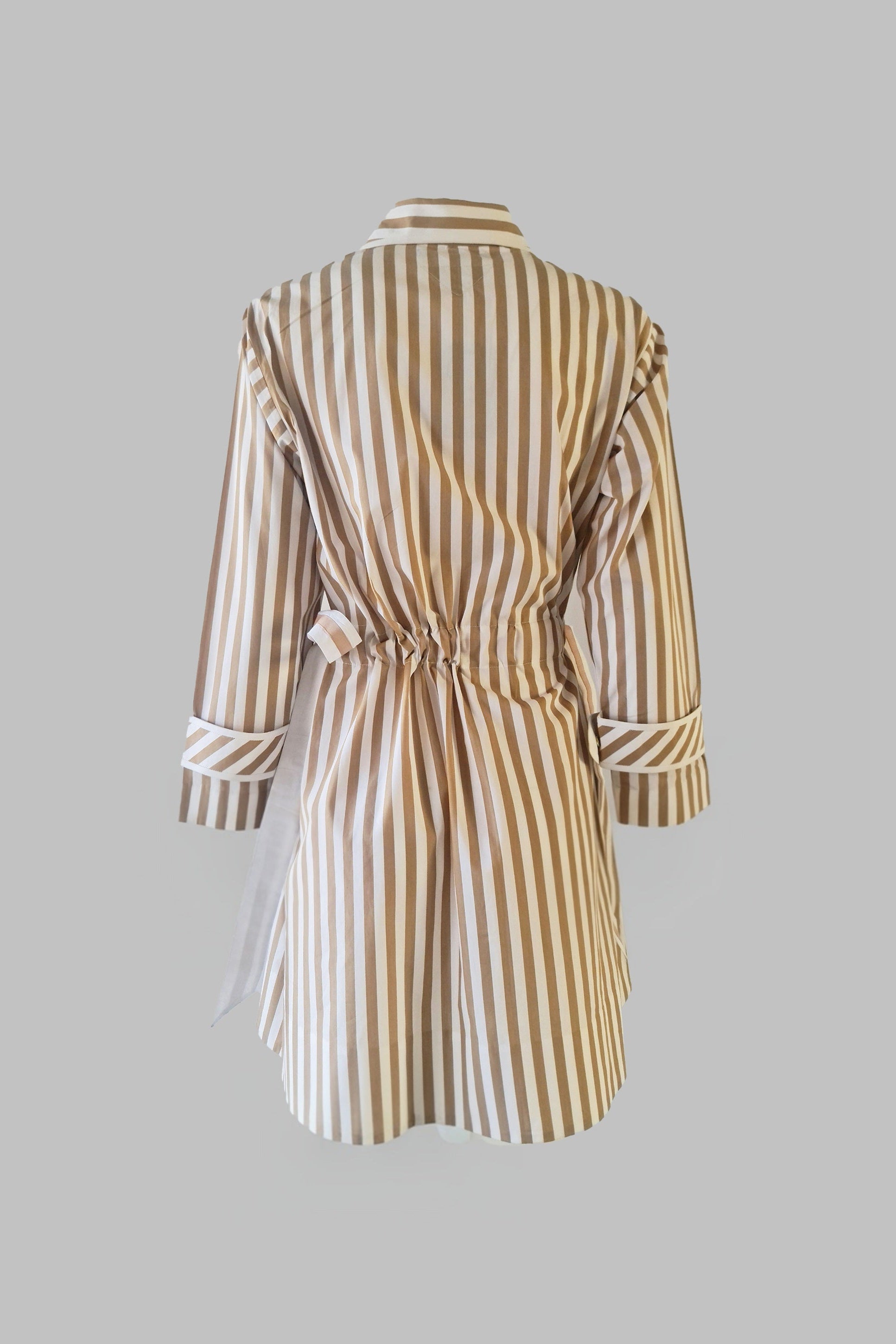 Striped dress on a mannequin against a gray background