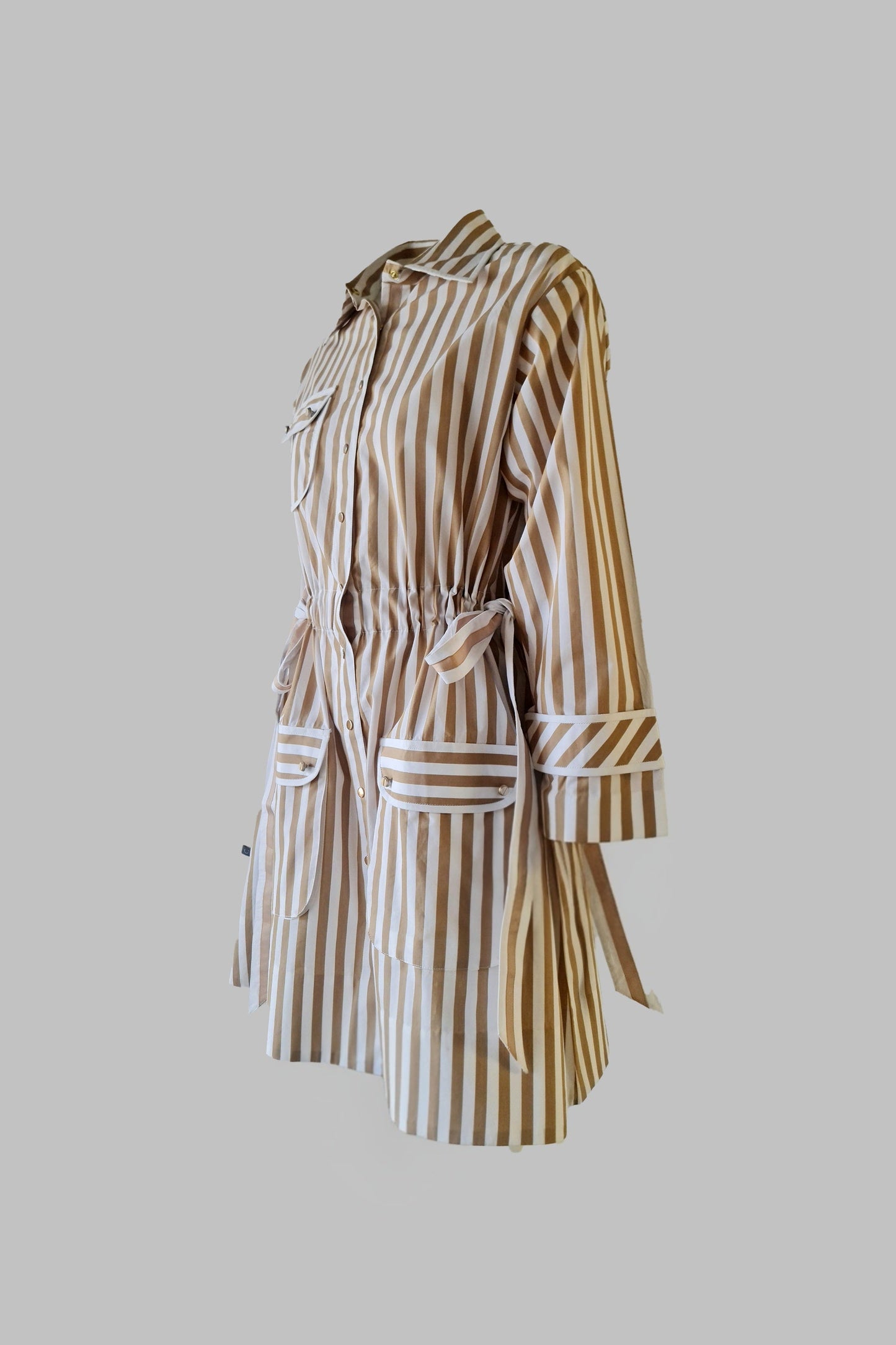 Striped dress with a belt on a gray background