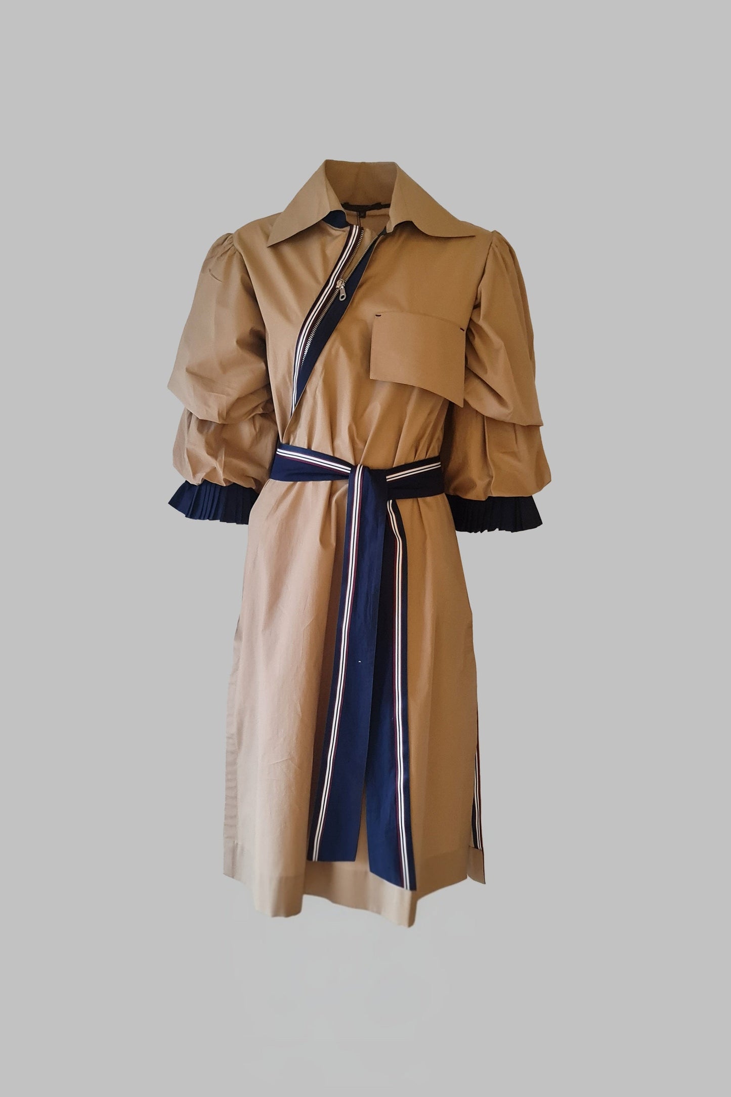 Beige trench coat with blue accents on a gray background