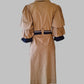 Tan trench coat with puff sleeves on a gray background