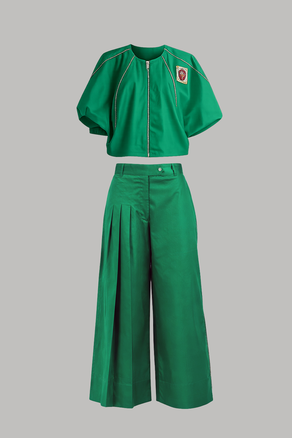 Green outfit with a top and wide-leg pants on a gray background
